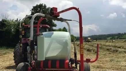 Bale wrapping machine applying Stretch Tech AGRIFLEX silage film in the field